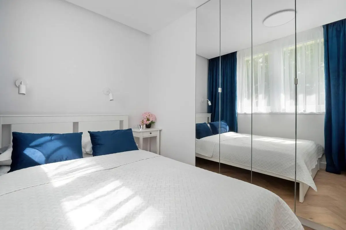 Image 2 of Blue and White Apartment in Łódź with Furnished Balcony by Noclegi Renters